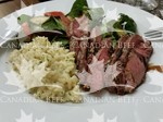 Top Sirloin drizzled with a rosemary garlic reduction, risotto and spinach salad
