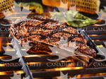 Bone in rib steak on grill